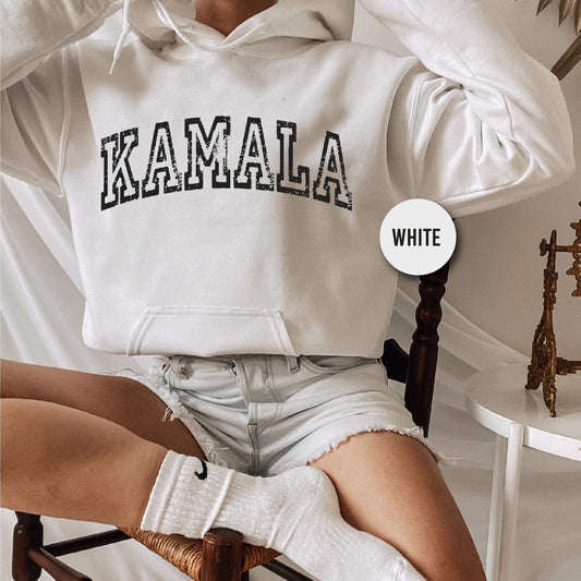 a woman sitting in a chair wearing a white hoodie