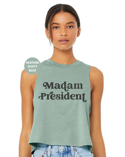 a woman wearing a tank top that says madam president