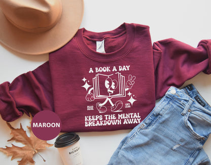 a t - shirt that reads a book a day keeps the mental breakdown away