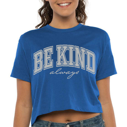 a woman wearing a blue be kind t - shirt