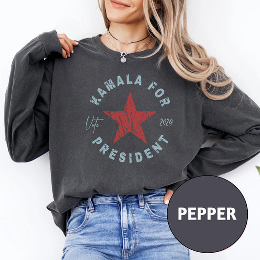 a woman wearing a black sweatshirt with a red star on it