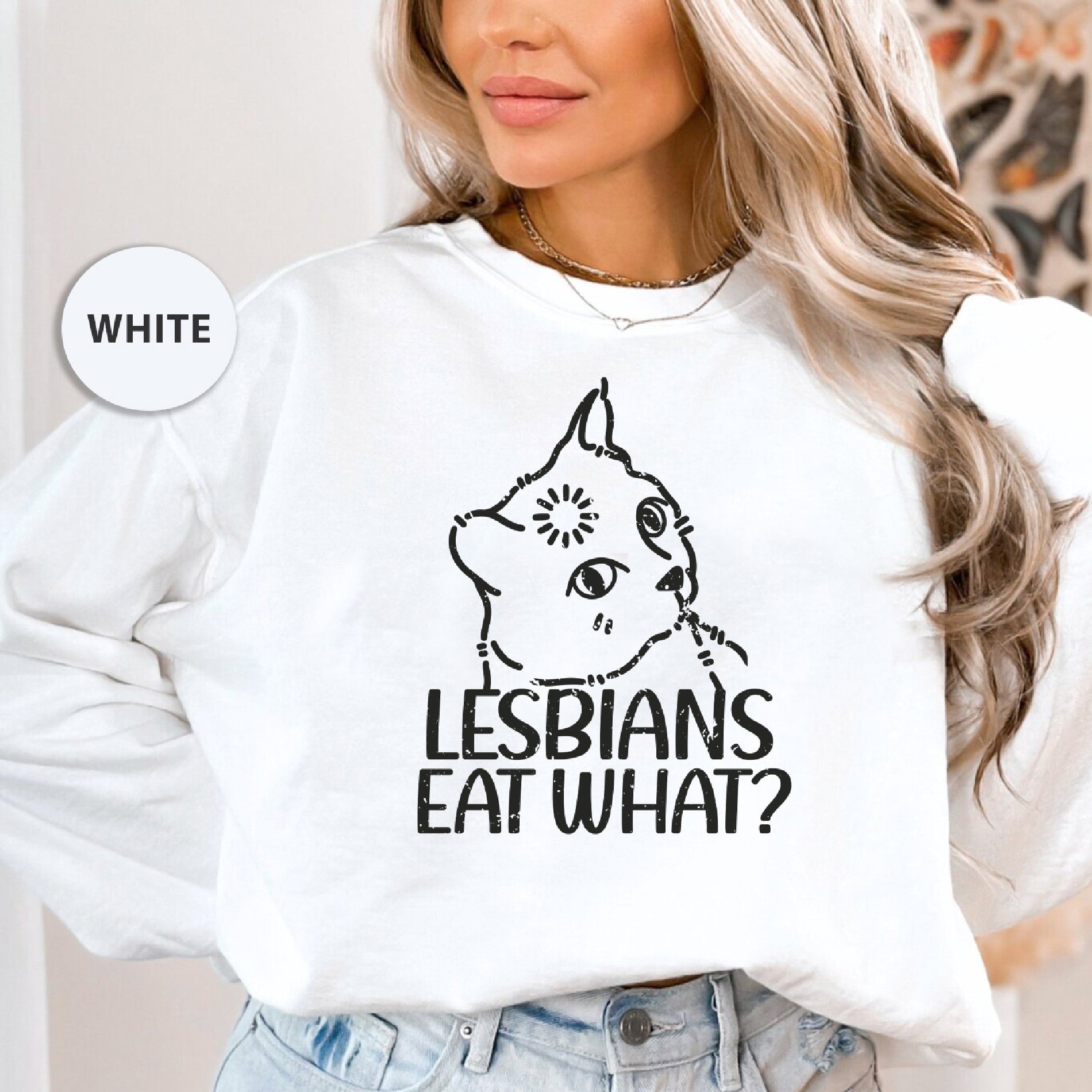 a woman wearing a white sweatshirt that says lesbians eat what?