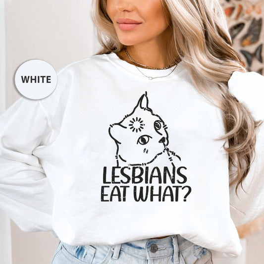 a woman wearing a white sweatshirt that says lesbians eat what?