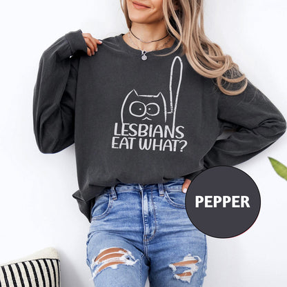 a woman wearing a sweatshirt that says lesbians eat what?