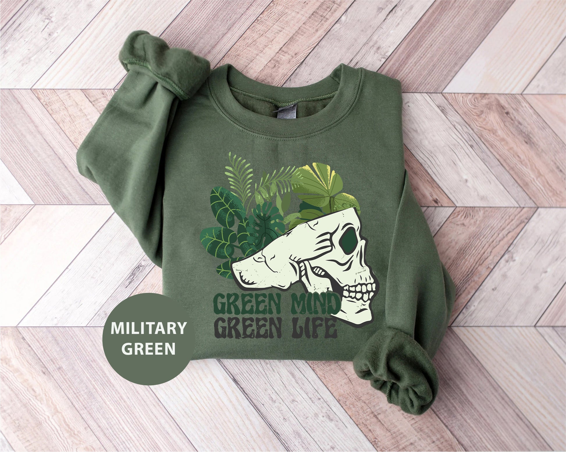 a green sweatshirt with a picture of a skull on it