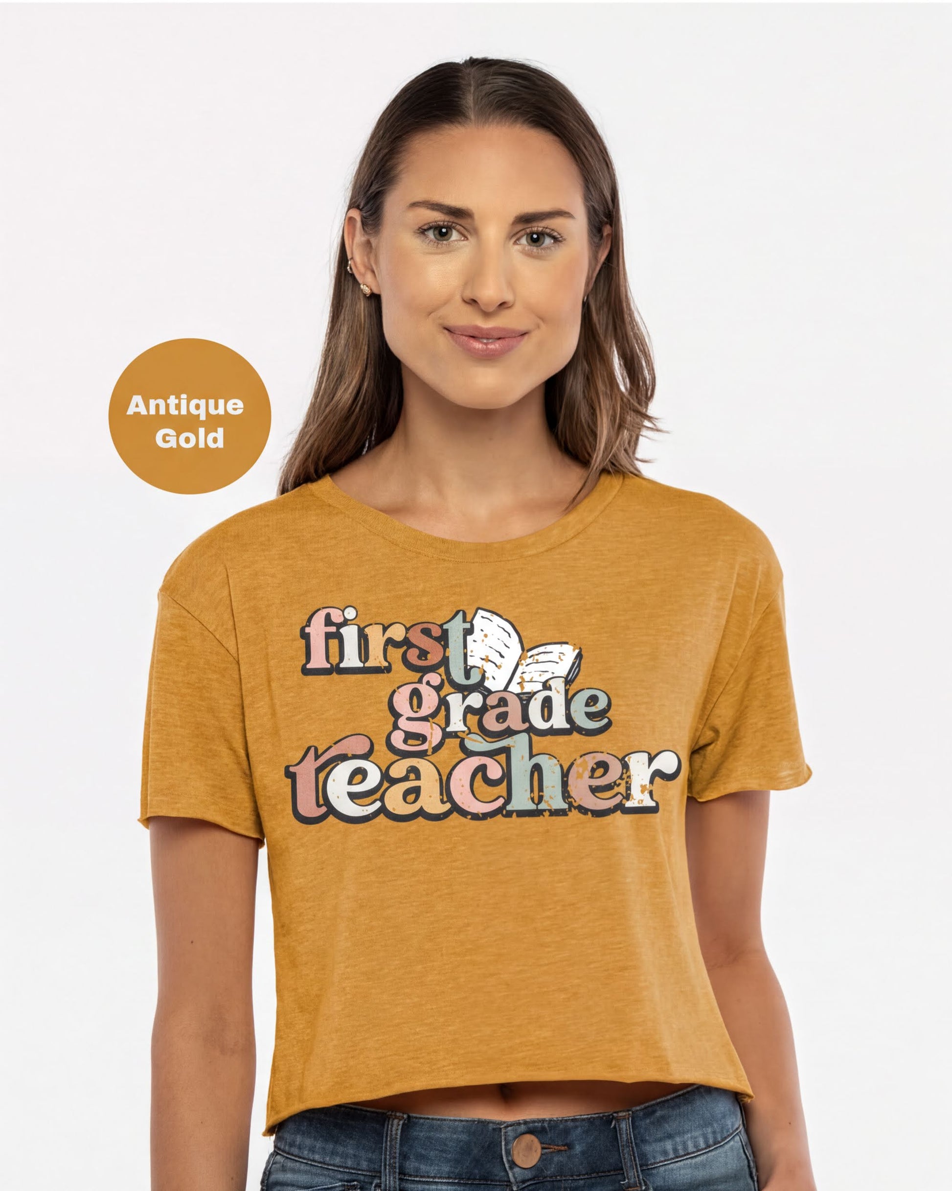 A woman wearing a yellow t-shirt with the text "first grade teacher" printed on it.