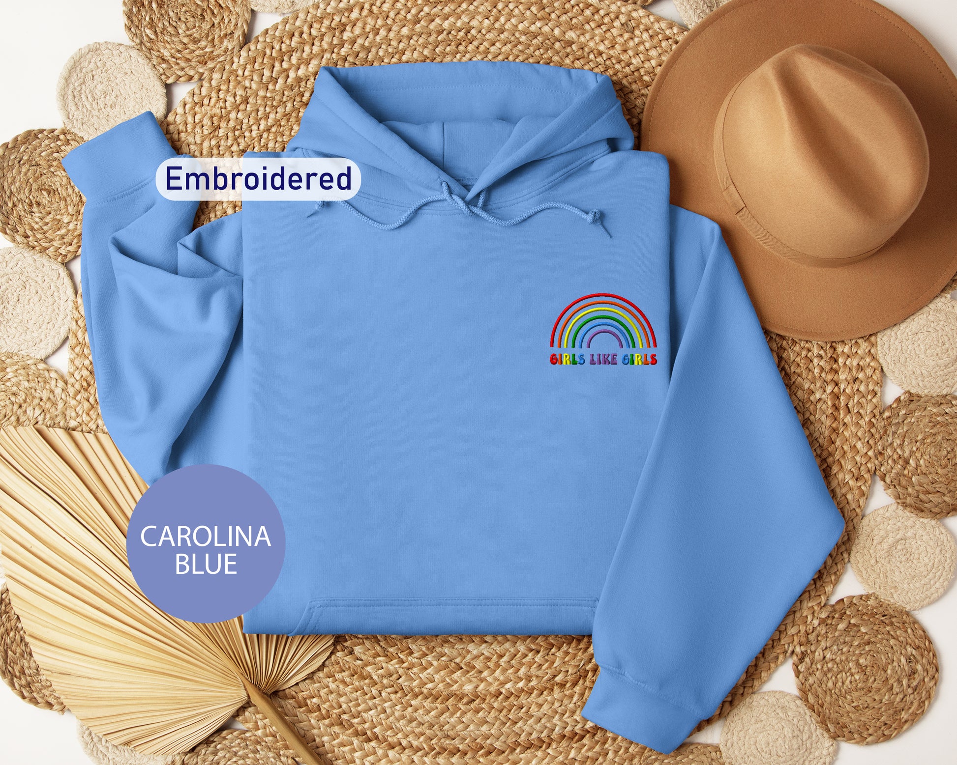 a blue hoodie with a rainbow embroidered on it