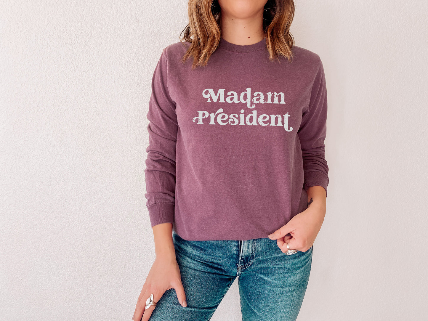 a woman wearing a sweatshirt that says madam president