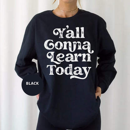 a woman wearing a black sweatshirt that says y'all conna learn today