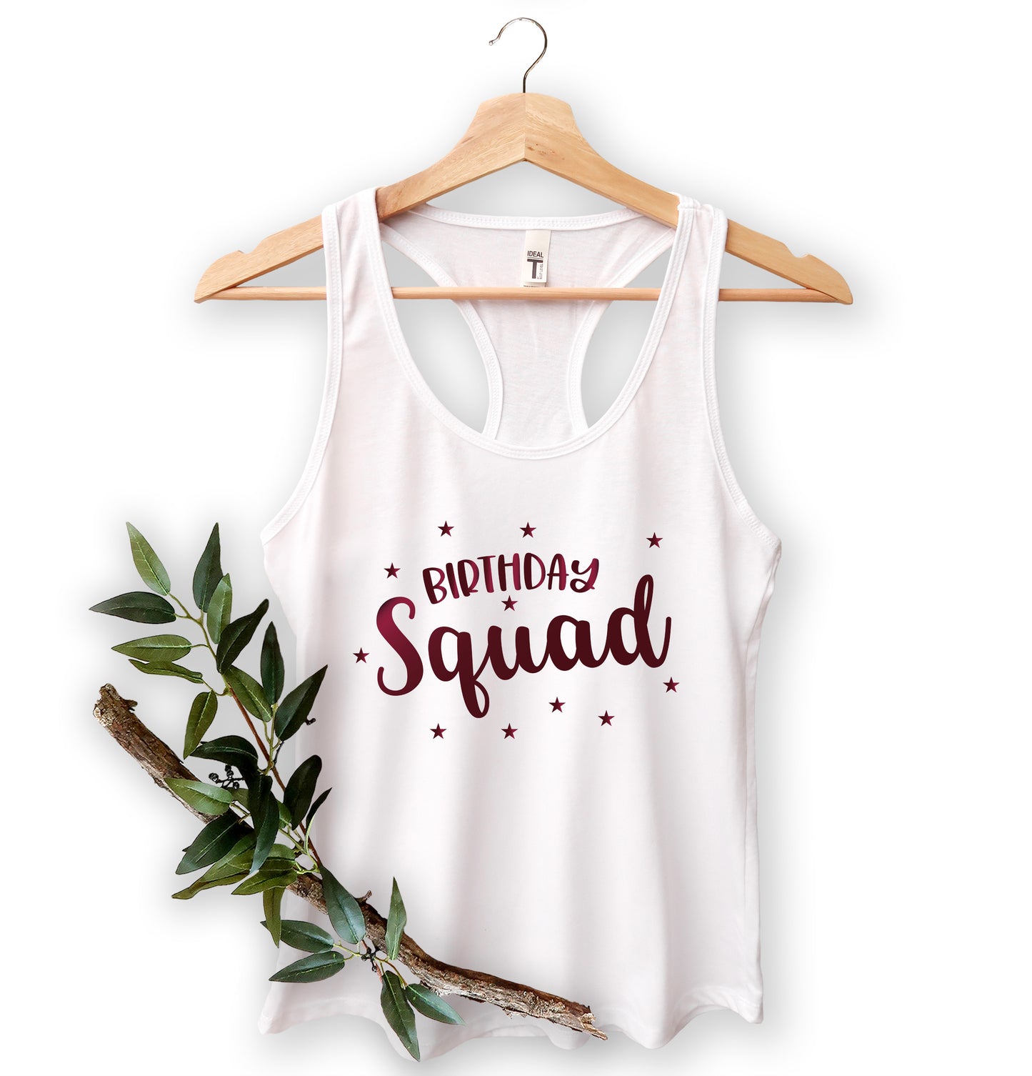 A white tank top with the text "Birthday Squad" printed on it, hanging on a wooden hanger.