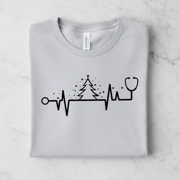 A gray t-shirt with a graphic design depicting a stethoscope and a Christmas tree with stars.