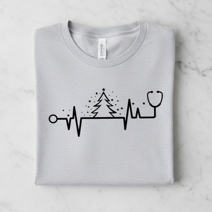 A gray t-shirt with a graphic design depicting a stethoscope and a Christmas tree with stars.