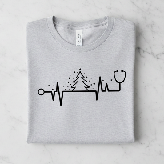 A gray t-shirt with a graphic design depicting a stethoscope and a Christmas tree with stars.