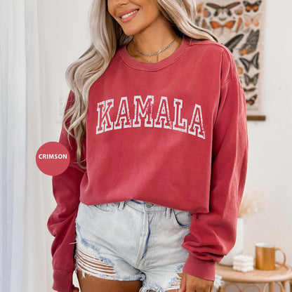 a woman wearing a red sweatshirt and denim shorts