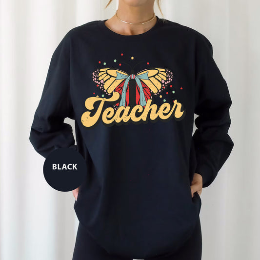 a woman wearing a black sweatshirt with a butterfly on it