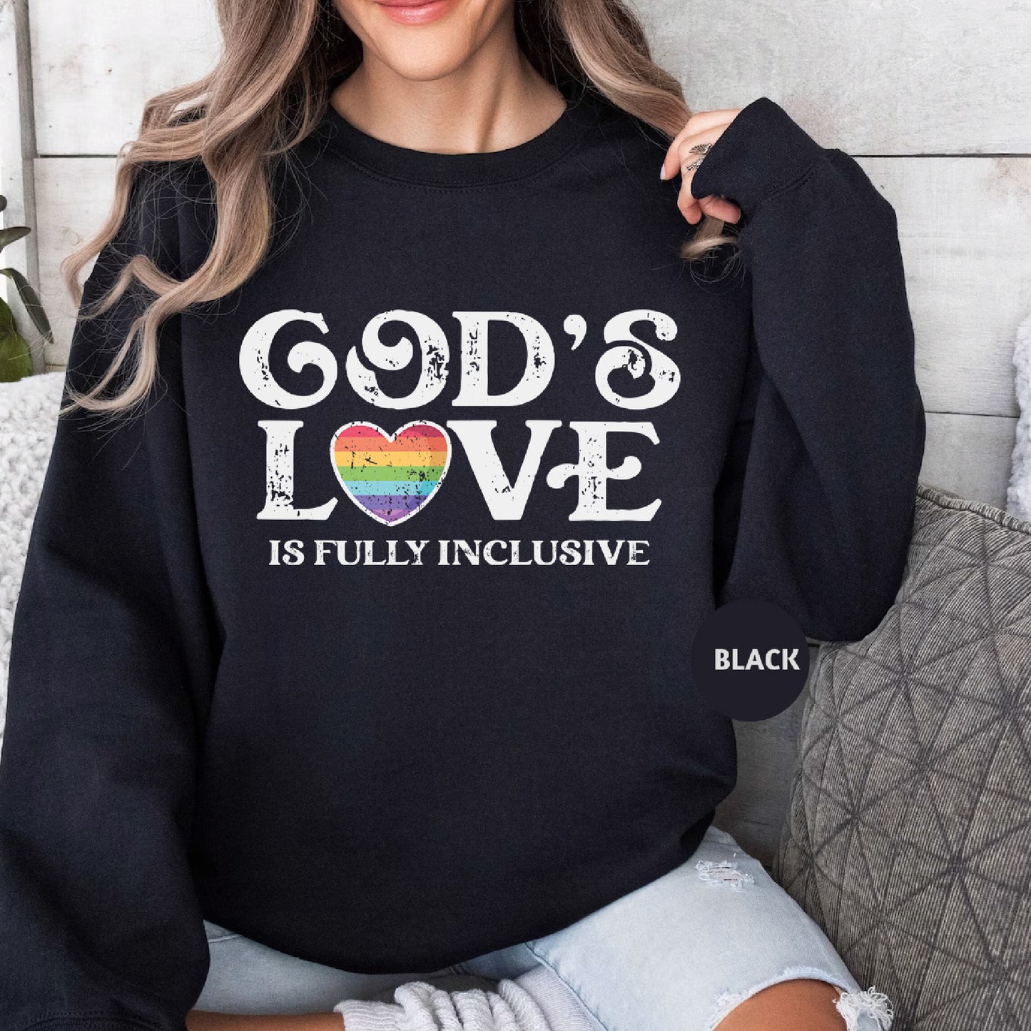 a woman wearing a black sweatshirt that says god's love is fully inclusive