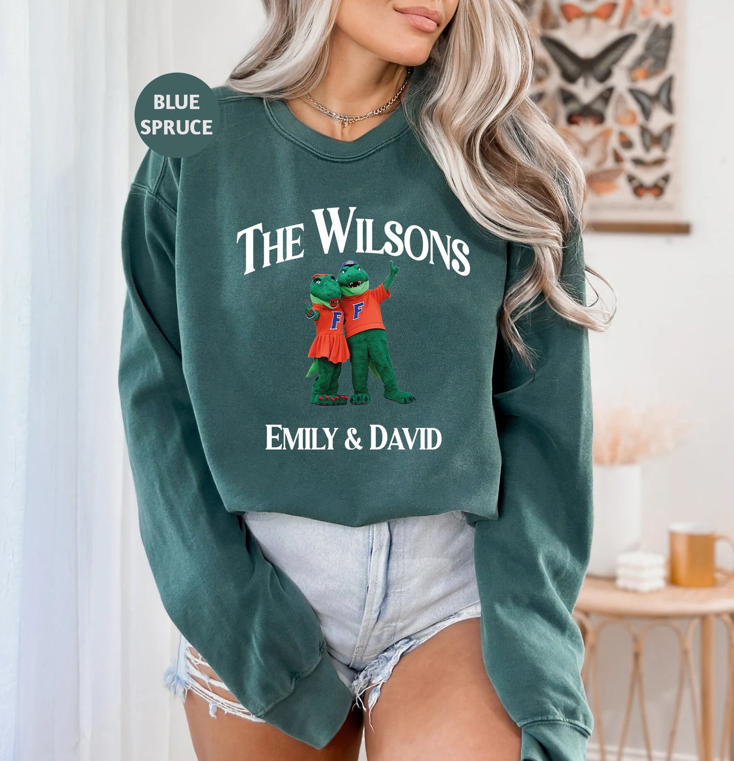 a woman wearing a green sweatshirt with the words the wilsons on it