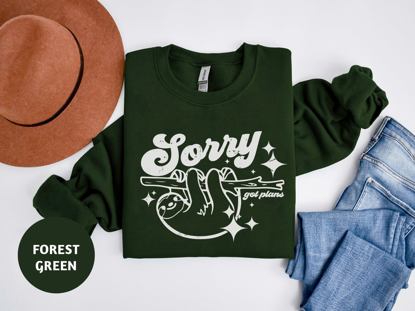 a t - shirt that says sorry and a hat next to it