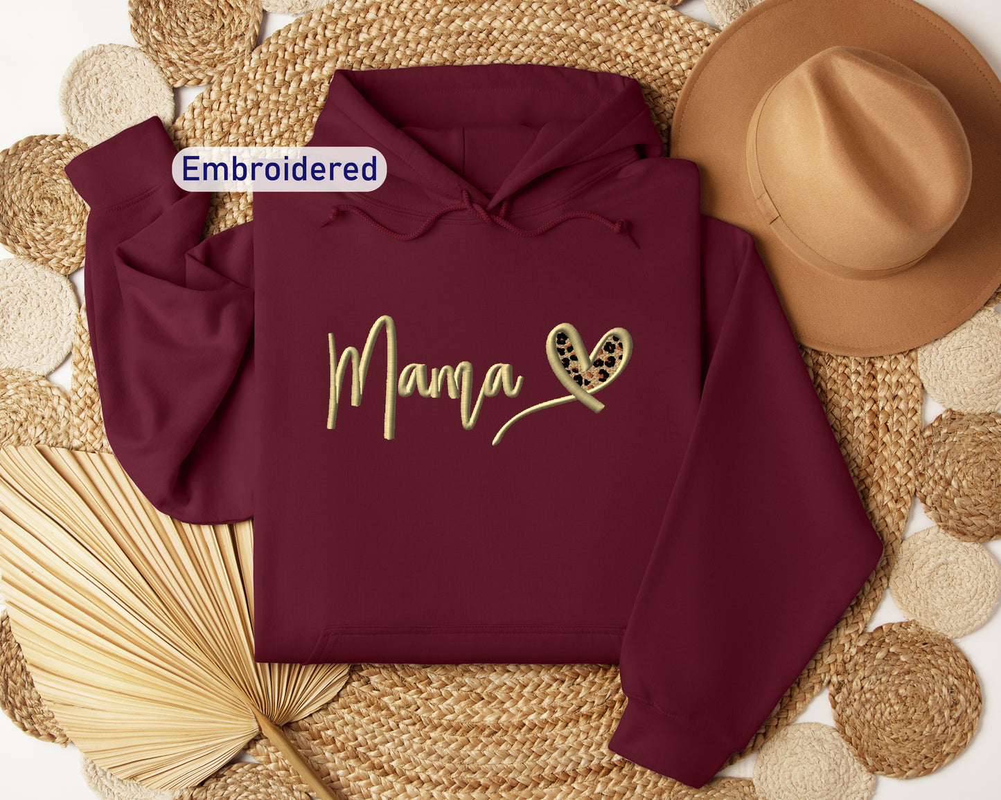 a maroon hoodie with the word mama printed on it