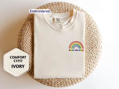 a white t - shirt with a rainbow embroidered on it