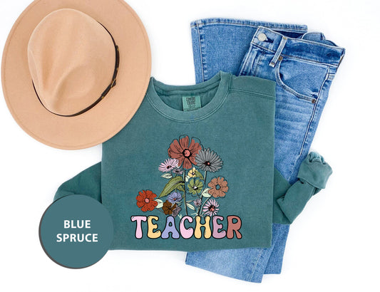 a hat, jeans, and a t - shirt with the words teacher on it