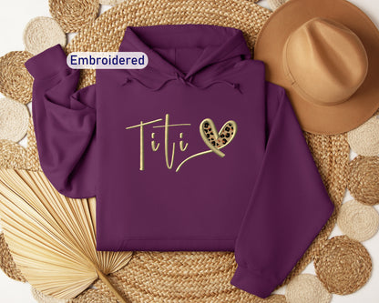 a purple hoodie with the word titi on it