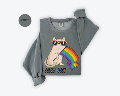 a gray shirt with a cat wearing sunglasses and a rainbow