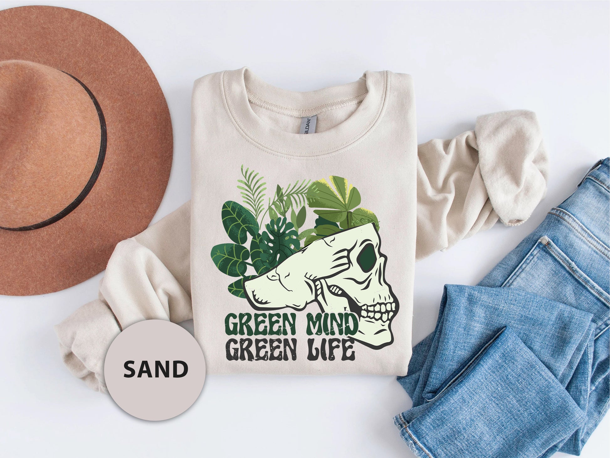 a t - shirt that says green mind and a hat next to it