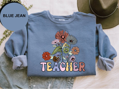 a blue jean shirt with a flower design on it