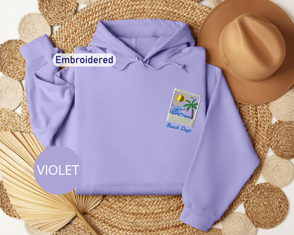 a purple hoodie with a beach-themed patch, a brown hat, and a woven mat, all arranged on a white background.