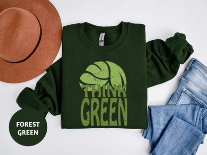 a t - shirt that says think green next to a hat and jeans