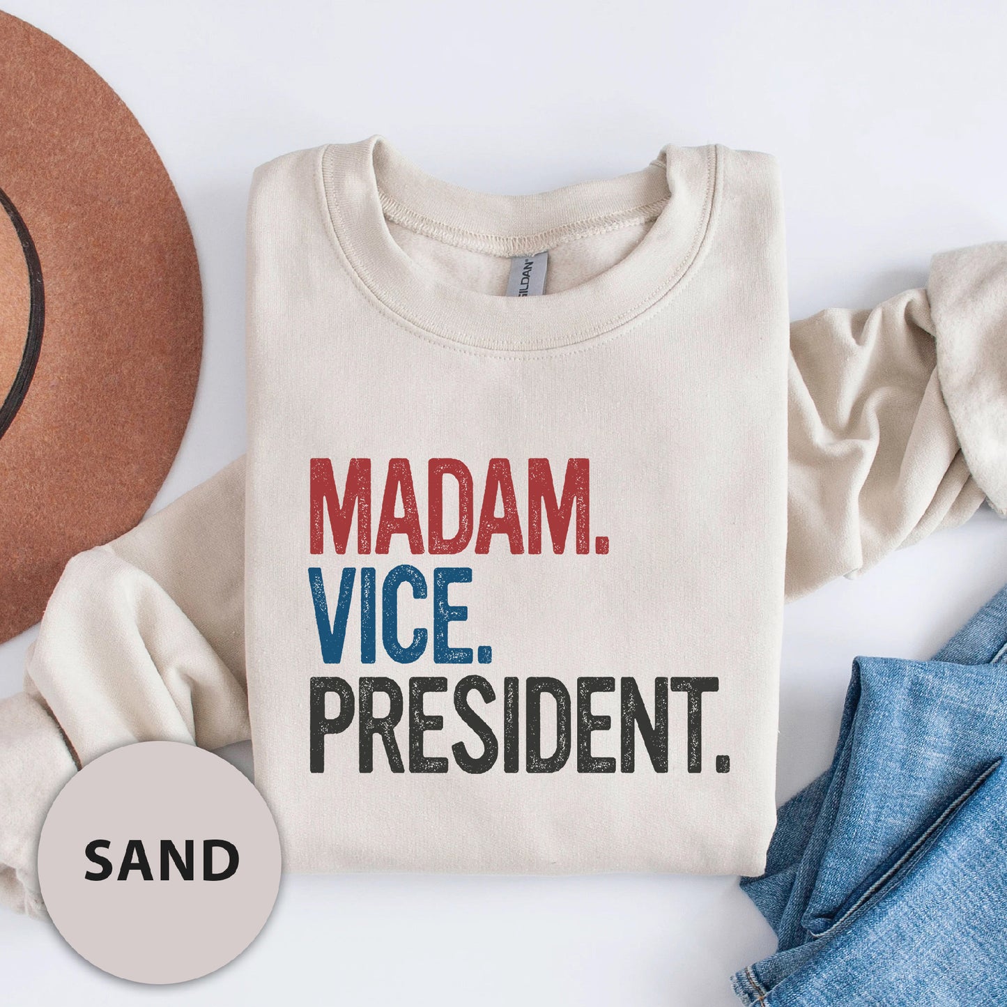 a t - shirt that says madam vice president next to a hat