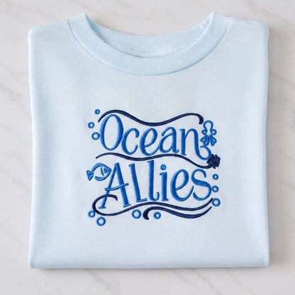 A light blue t-shirt with the text "Ocean Allies" embroidered on it.