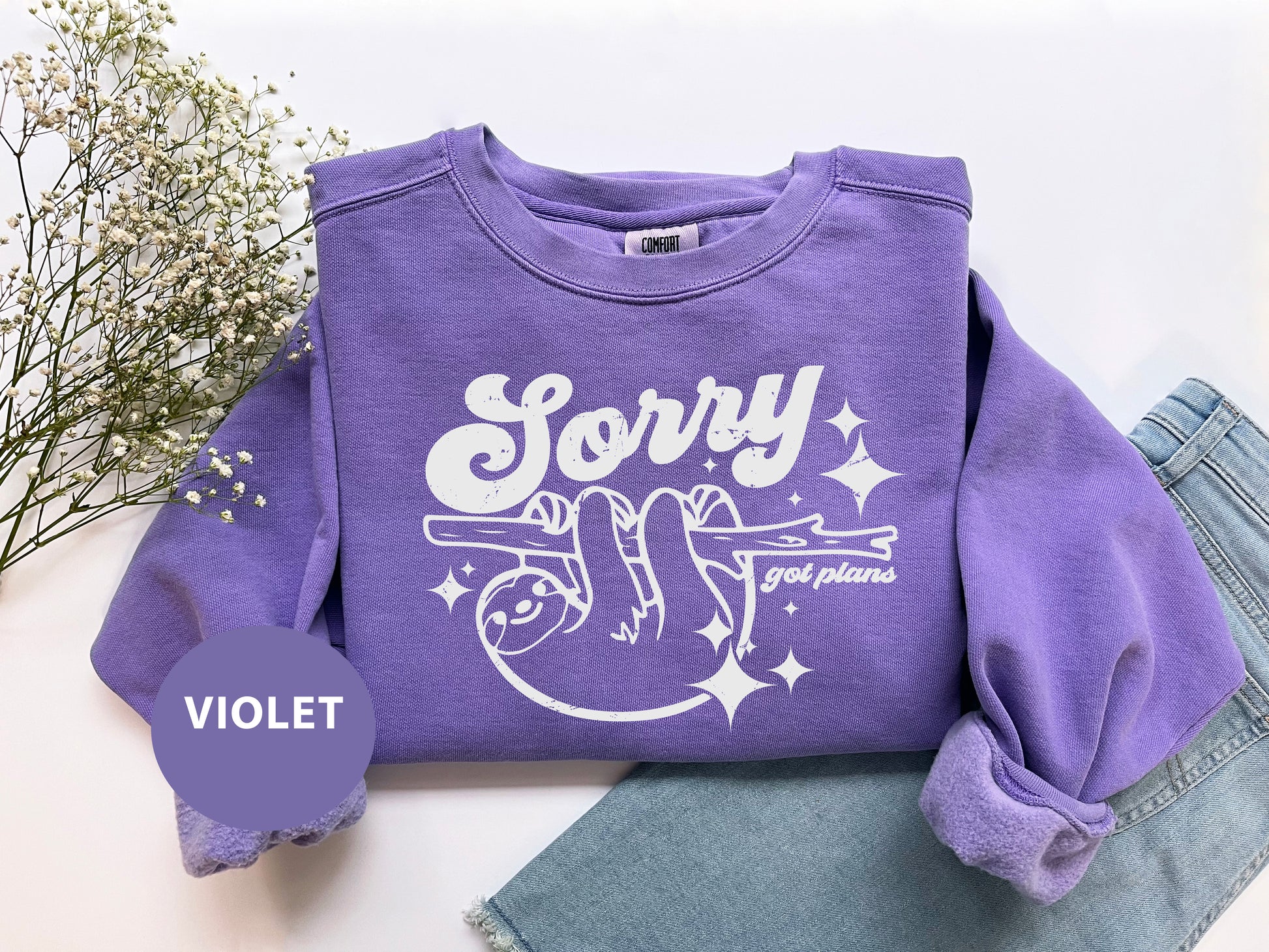 a purple shirt that says sorry on it