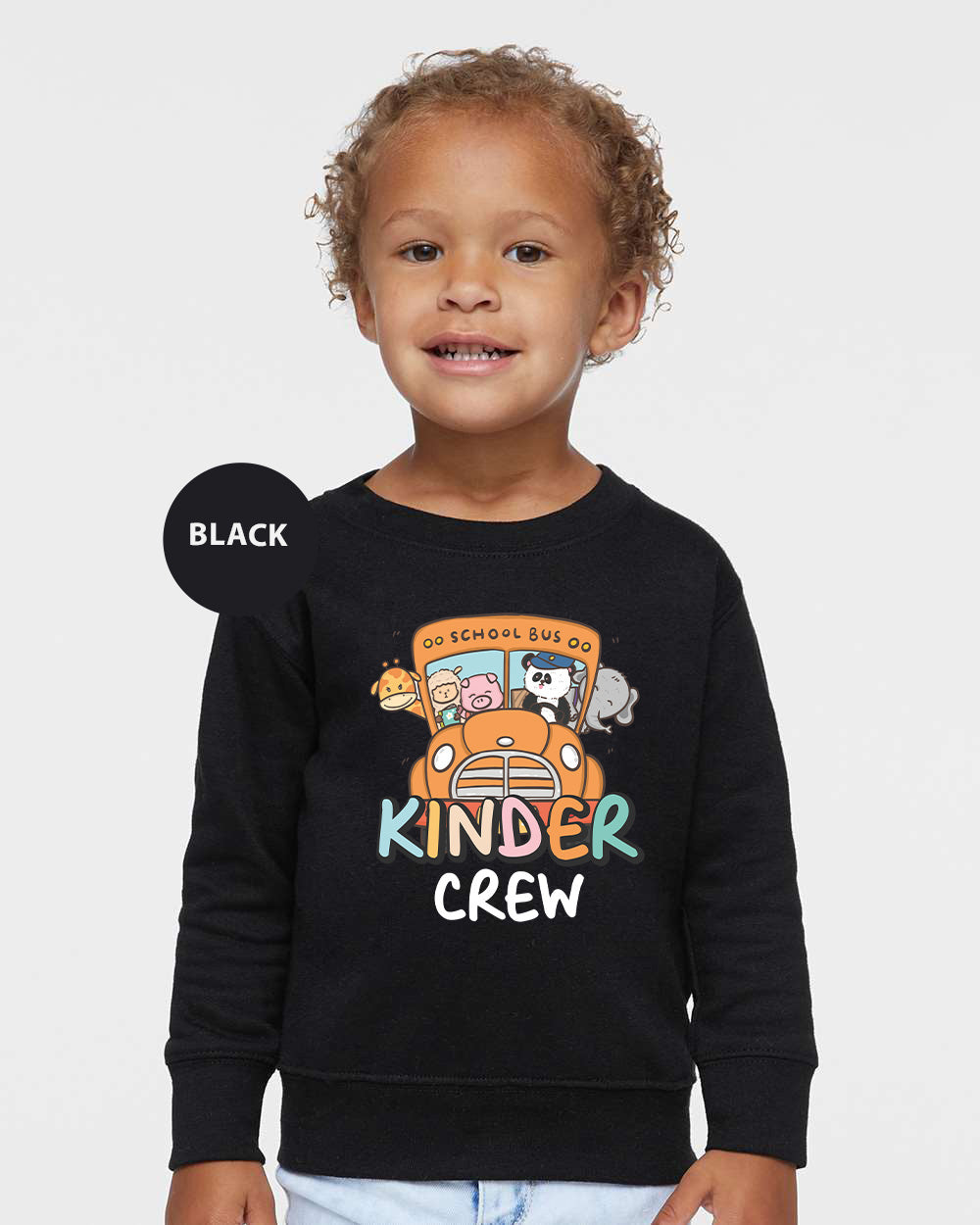 a young child wearing a black sweater with a cartoon character on it