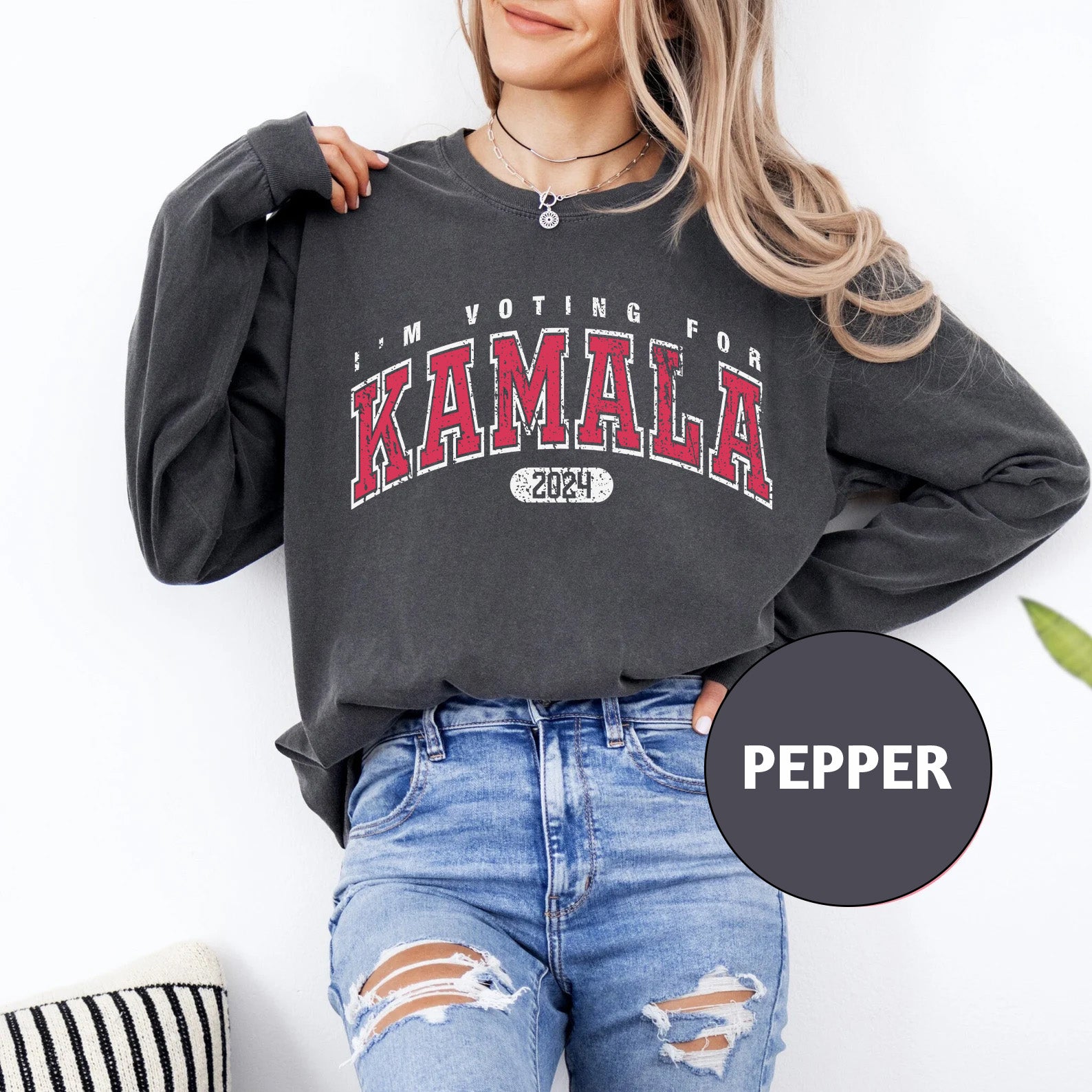 a woman wearing a black sweatshirt with the words, i'm voting for ka