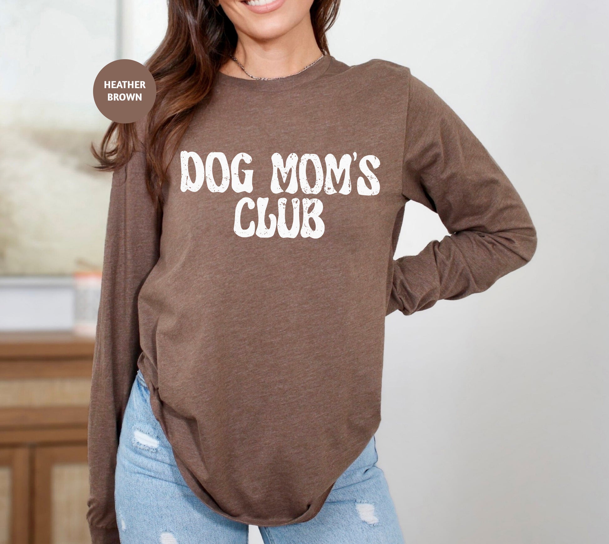 a woman wearing a brown dog mom's club shirt