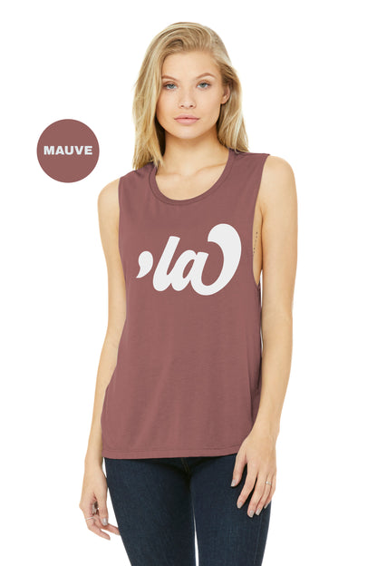 a woman wearing a tank top with the word la on it