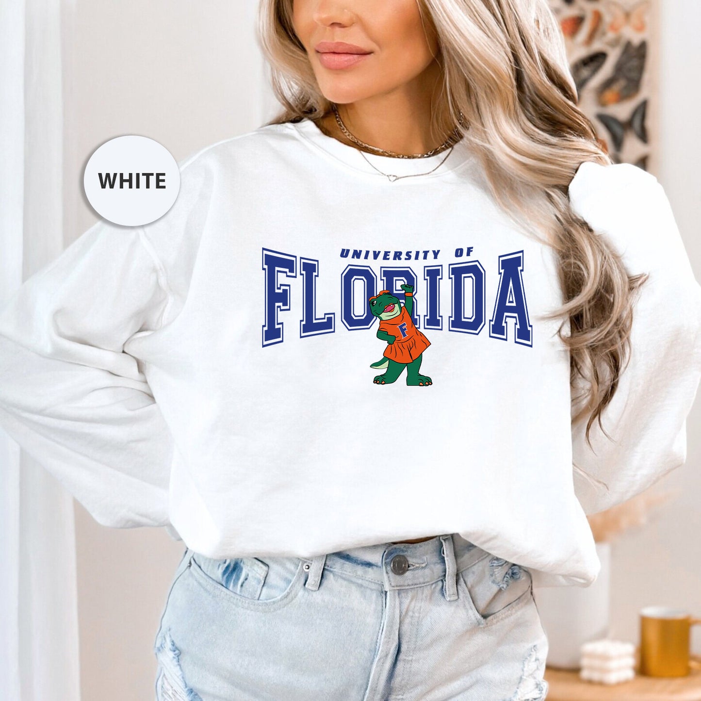 a woman with blonde hair wearing a white florida sweatshirt