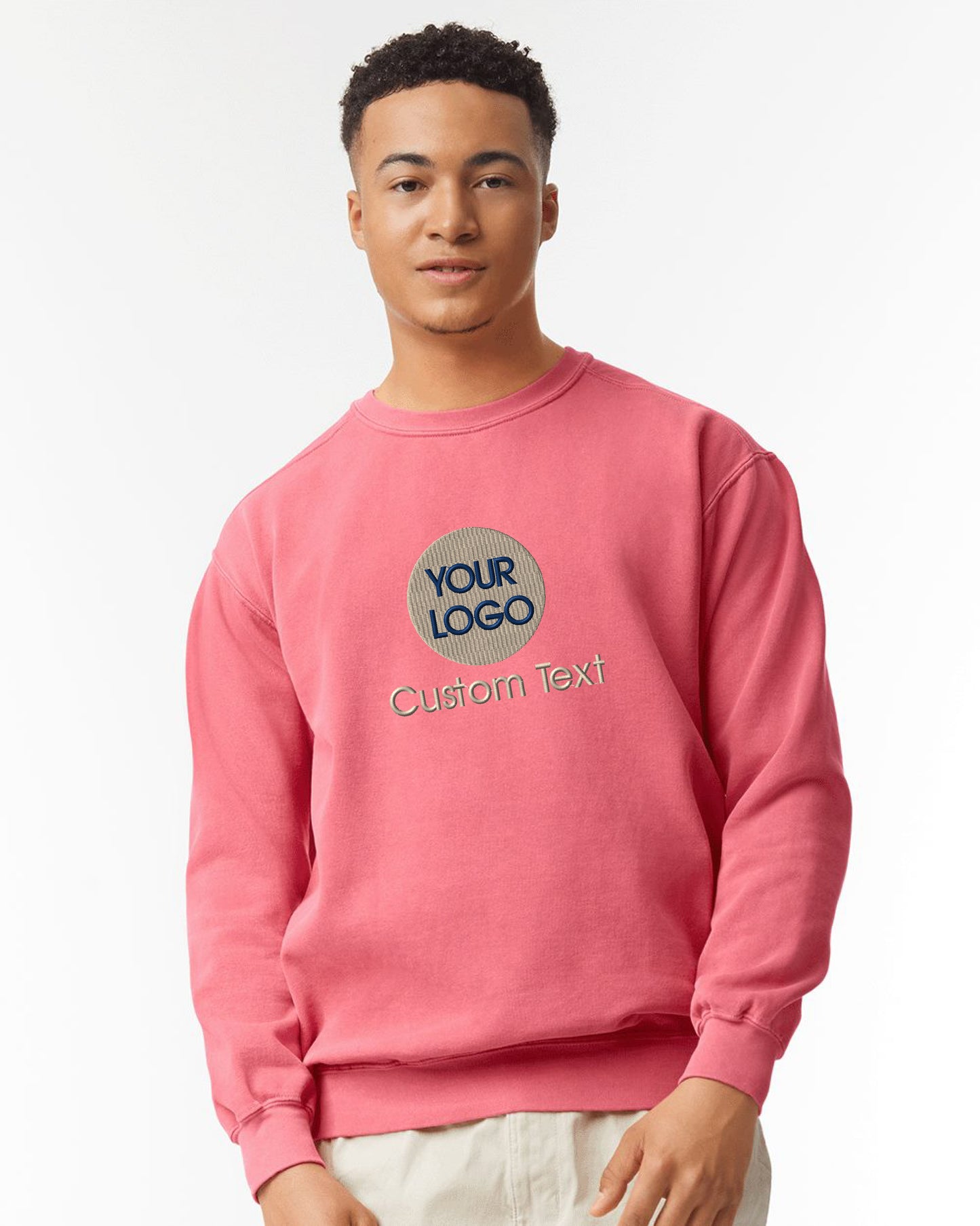 a man wearing a pink sweatshirt with the words your logo on it