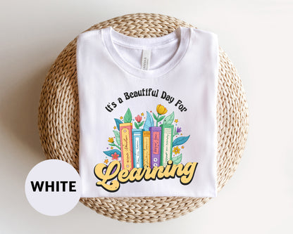 a white t - shirt that says it's a beautiful day to be learning