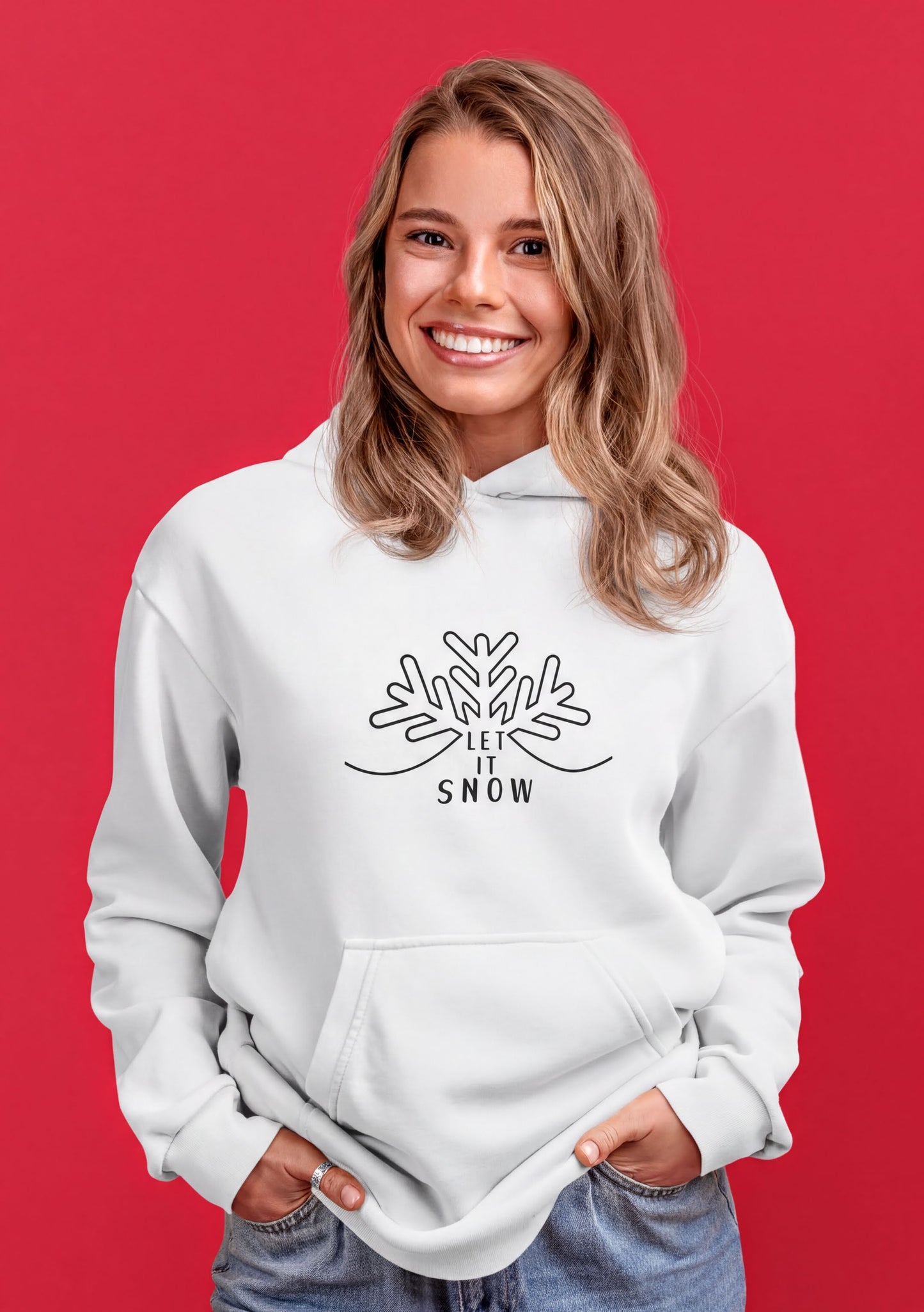 A smiling woman wearing a white hoodie with a snowflake design and the text "LET IT SNOW" printed on it.