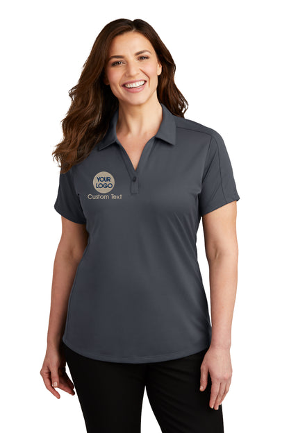 a woman wearing a grey polo shirt with a logo on it