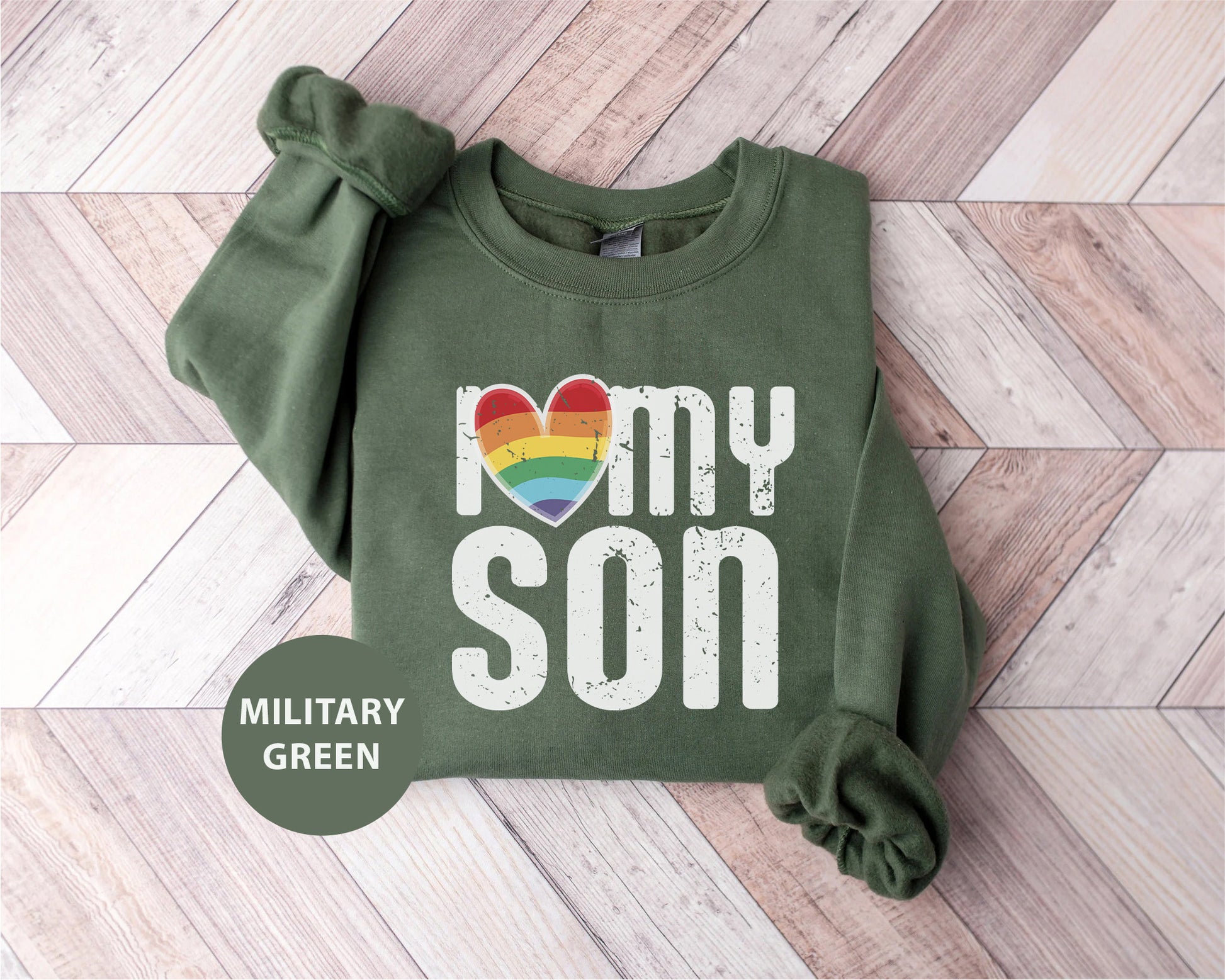 a green sweatshirt with a rainbow heart and the words i love my son on it