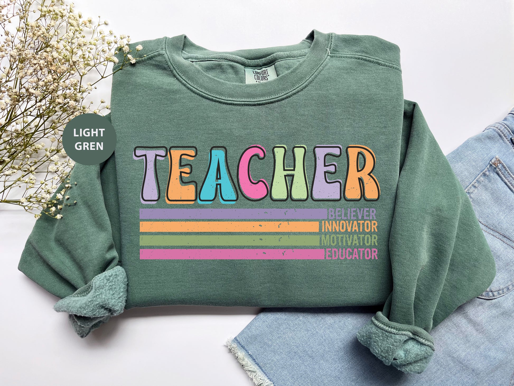 a green shirt with the words teacher on it