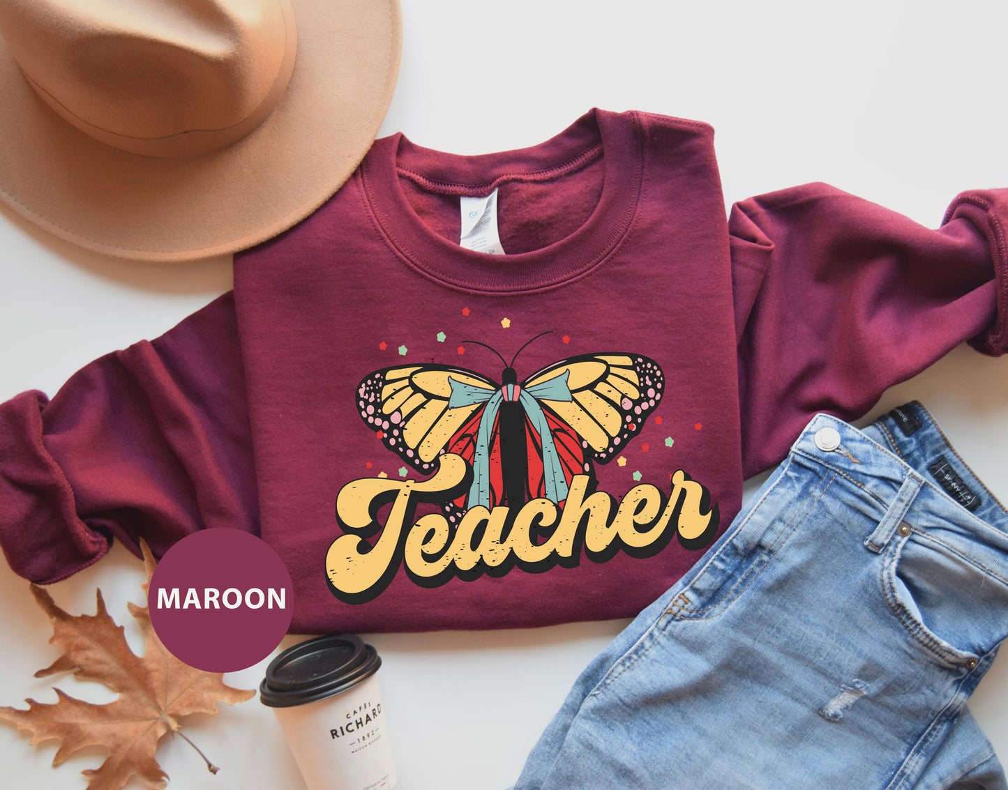 a maroon shirt with a butterfly and name on it