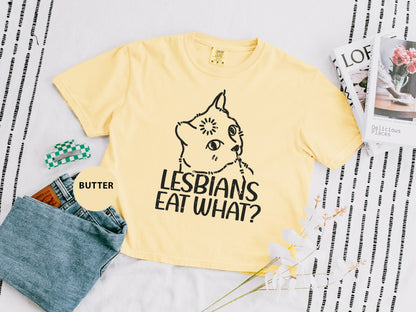 a t - shirt that says lesbians eat what? next to a pair of