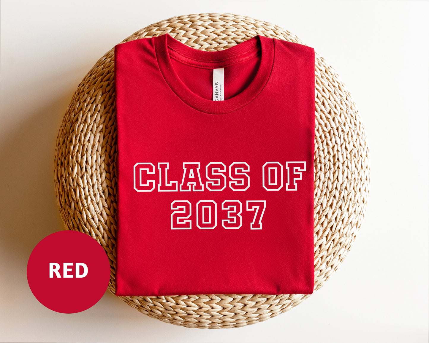 a red shirt that says class of 202 next to a wicker basket