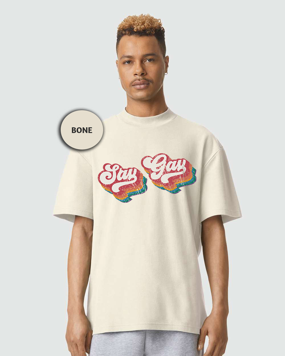 a man wearing a white shirt with the words stay gay on it