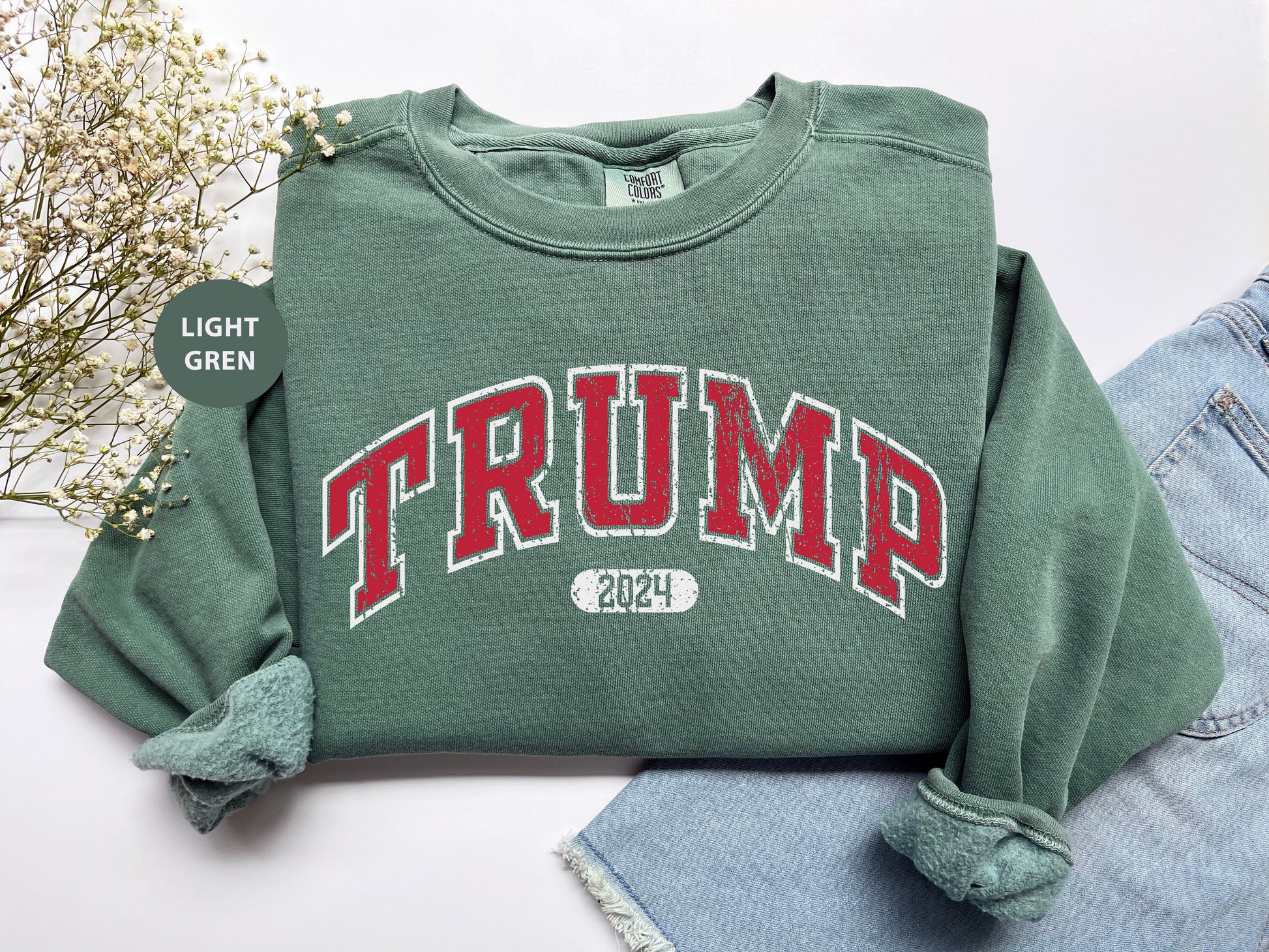 a green sweatshirt with the word trump printed on it